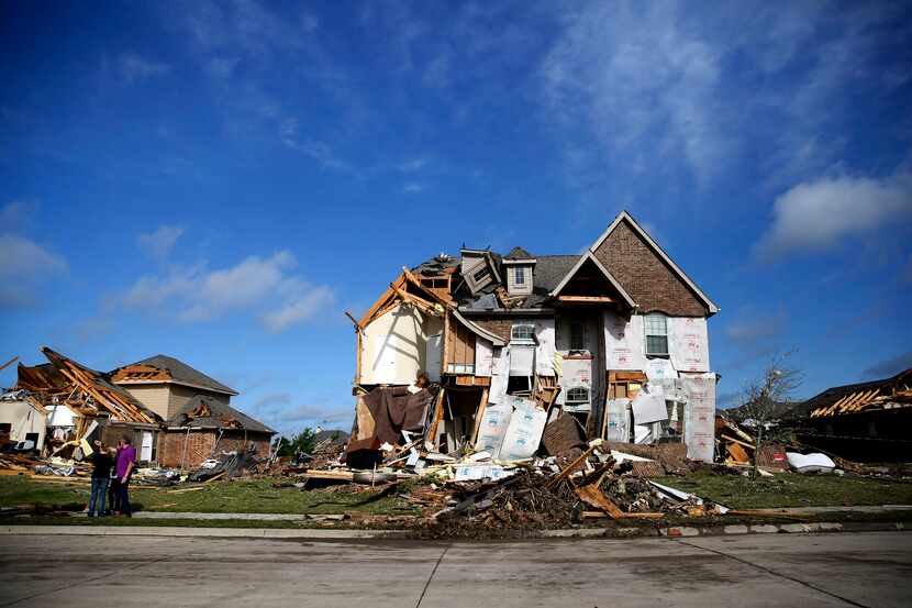 Damaged homes along Panhandle Drive following a storm in the early hours of the morning in...