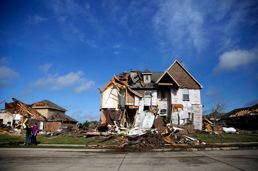 Damaged homes along Panhandle Drive following a storm in the early hours of the morning in...