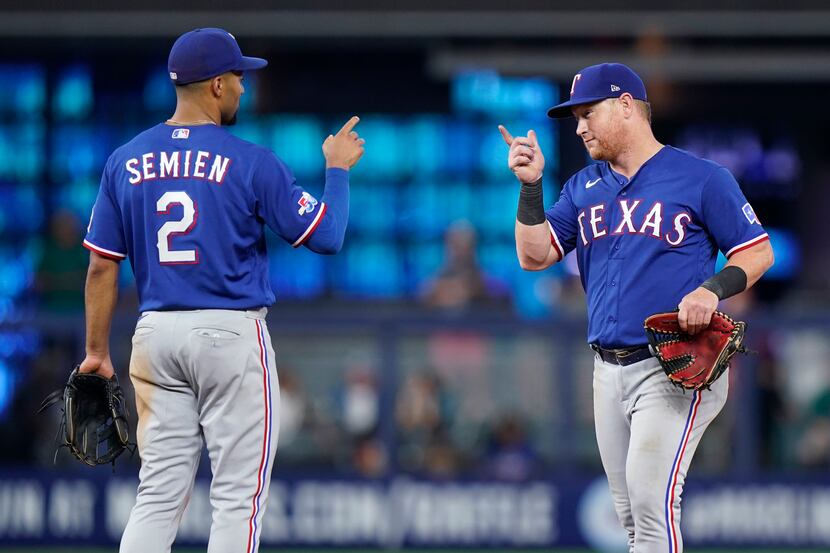 Texas Rangers shortstop Marcus Semien (2) and left fielder Kole Calhoun celebrate after the...