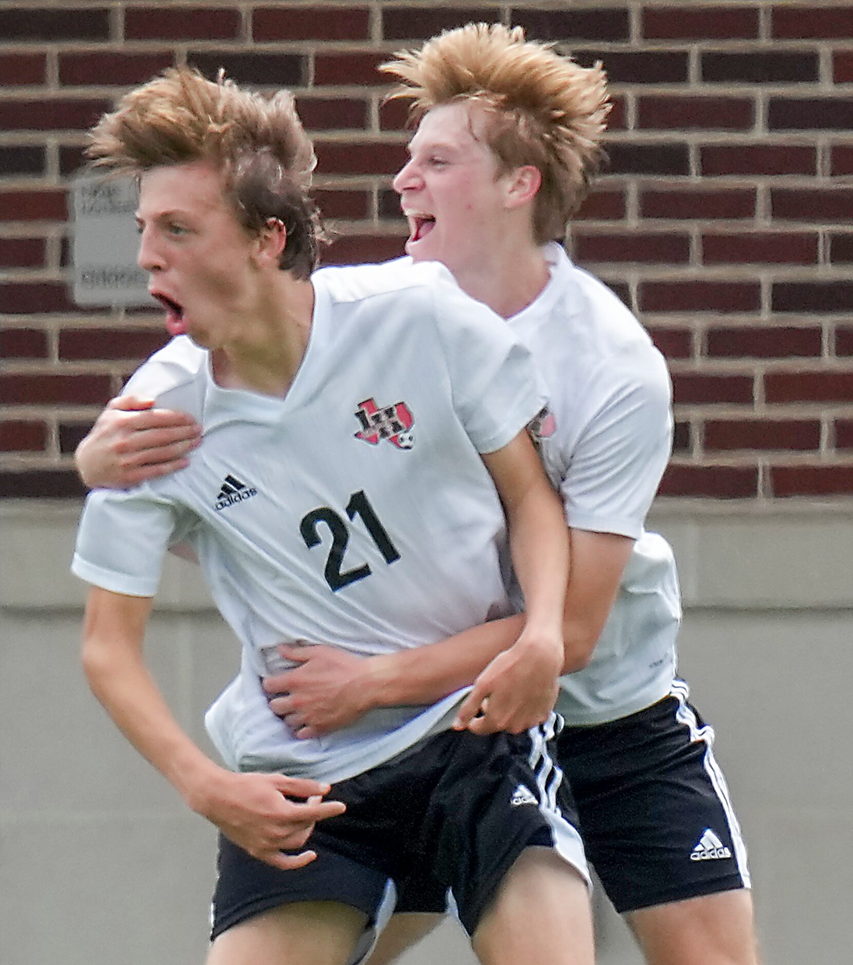 Lake Highlands midfielder James Boone (21) celebrates with defender Charlie Willmann after...