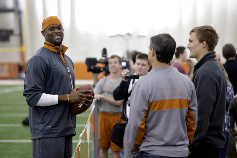 Former University of Texas and NFL quarterback Vince Young, left, talks with Texas...