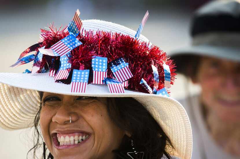 Ying Barab smiled under a hat covered with flags during the Fair Park Fourth celebration in...