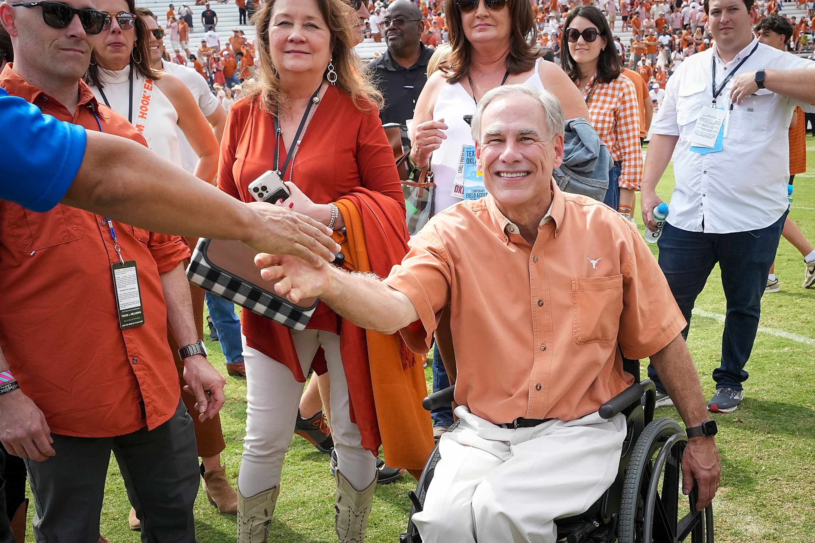 Texas Governor Greg Abbott celebrates on the field after the Longhorns victory over Oklahoma...