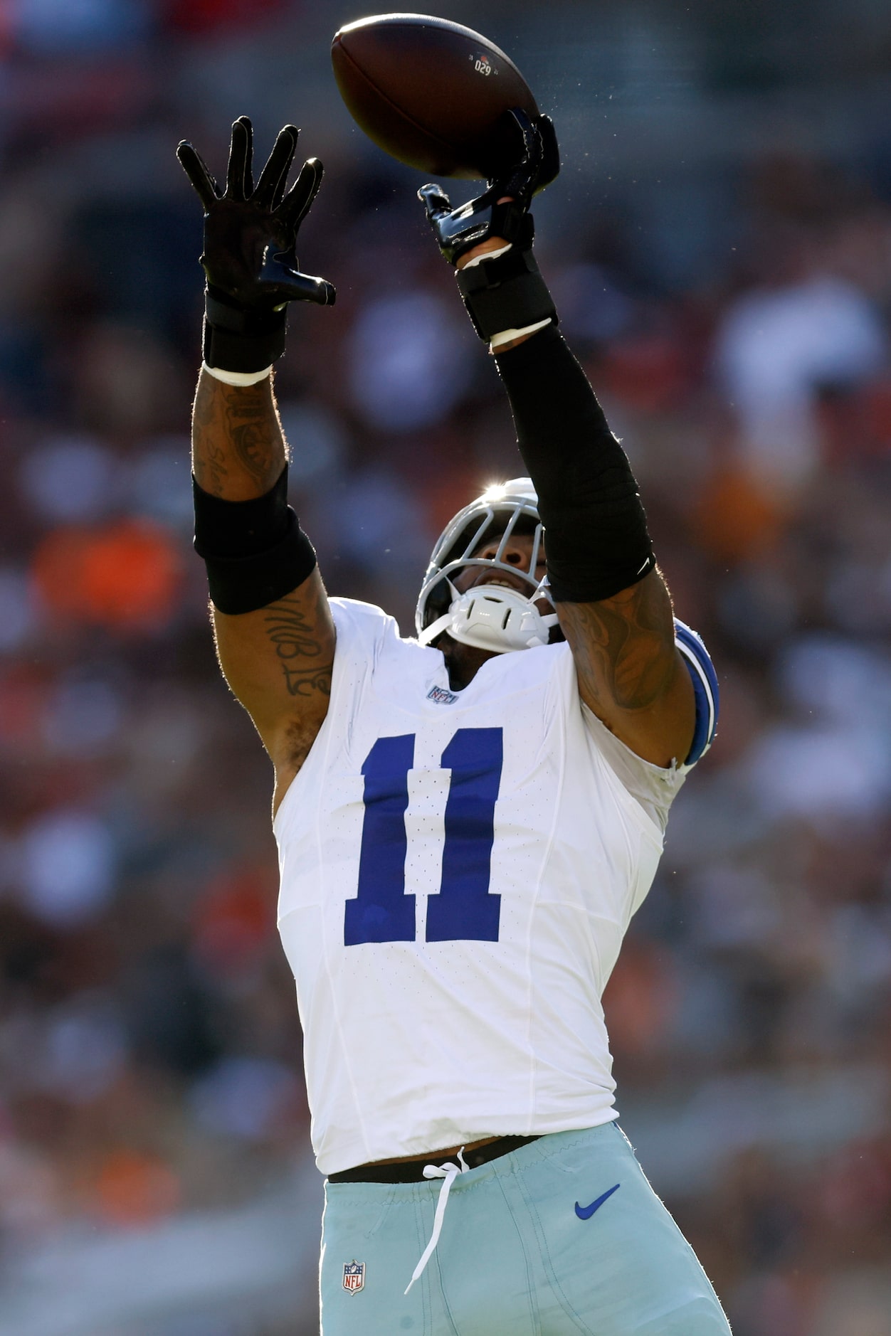 Dallas Cowboys linebacker Micah Parsons (11) leaps to tip a pass from Cleveland Browns...