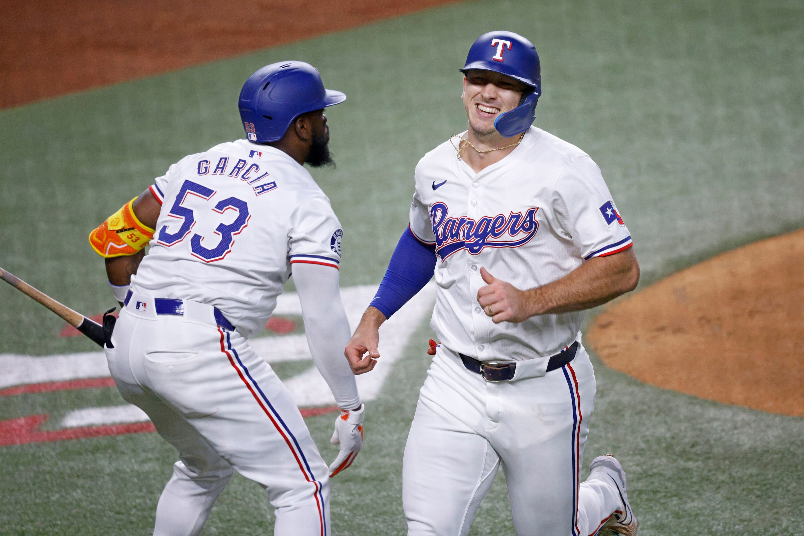 Texas Rangers’ Wyatt Langford (36) smiles to Texas Rangers designated hitter Adolis García...