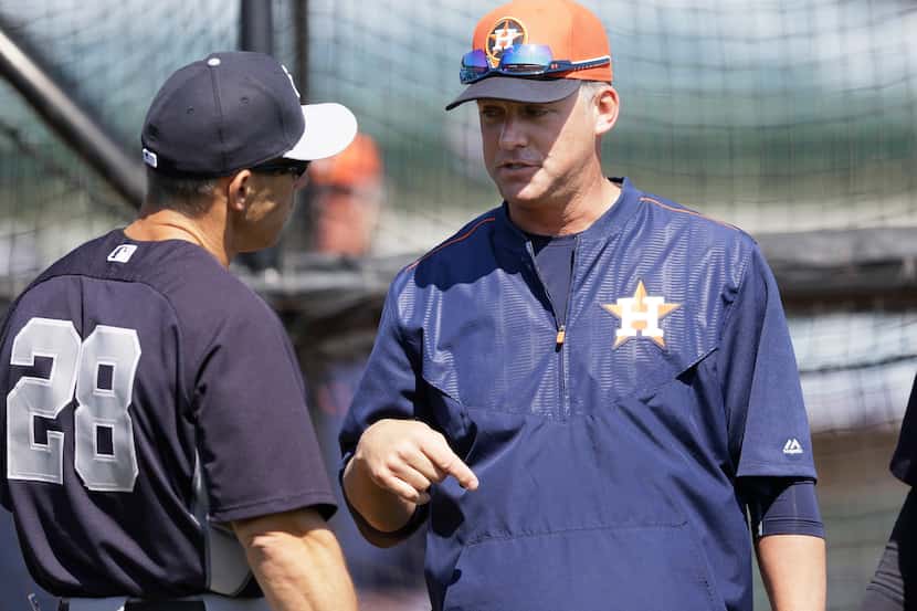 New York Yankees manager Joe Girardi, left, and Houston Astros manager A.J. Hinch meet...