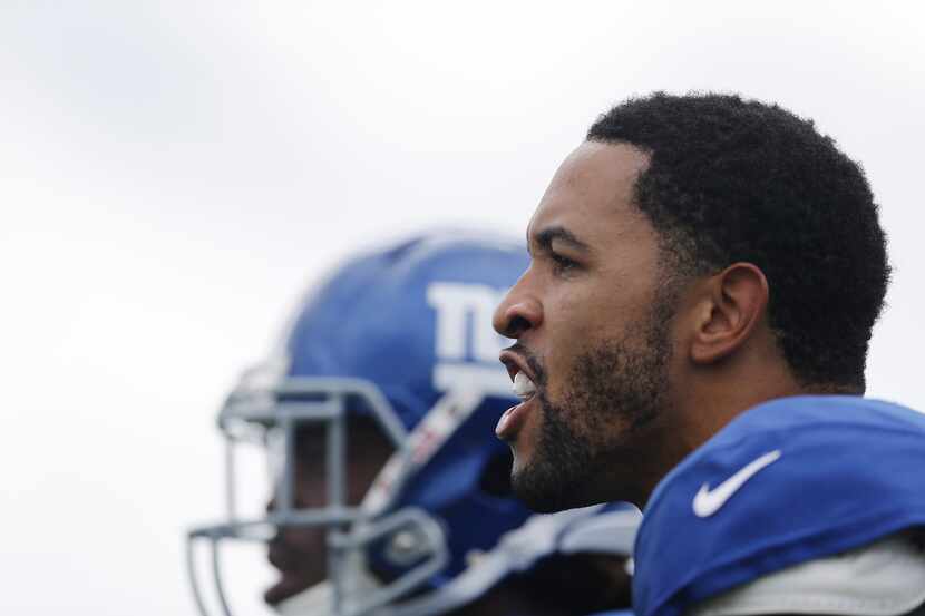 New York Giants defensive back Terrell Thomas cheers for teammates during NFL football...