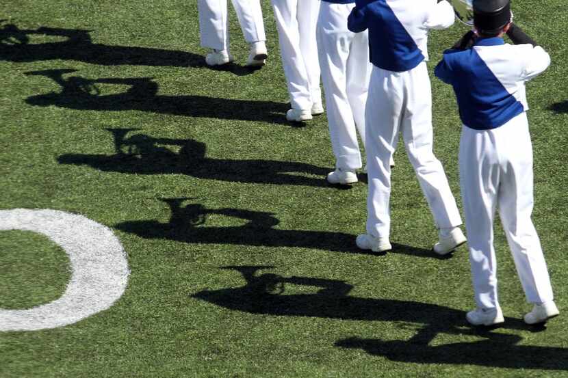 Members of the Allen marching band cast shadows in perfect form during their halftime...