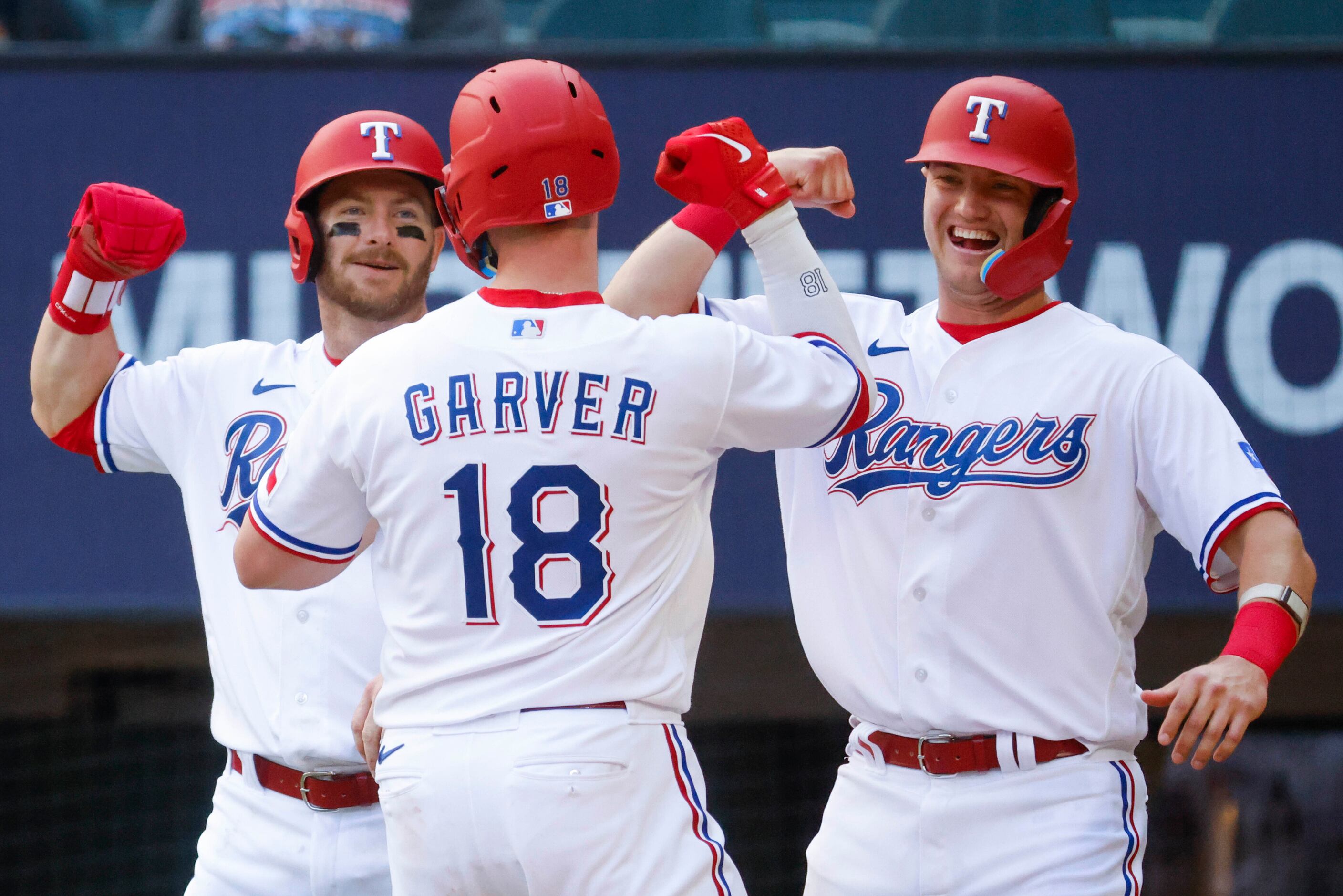 Texas Rangers left fielder Robbie Grossman (left) and third baseman Josh Jung (right) cheers...