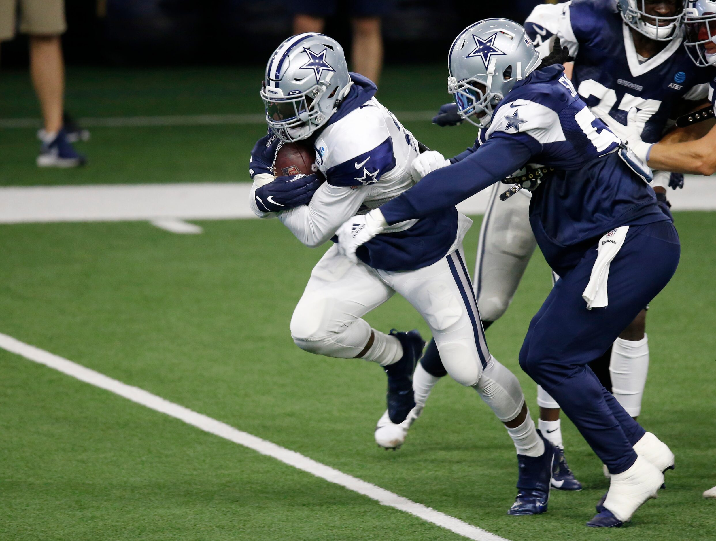 Dallas Cowboys running back Ezekiel Elliott (21) is caught by Dallas Cowboys linebacker...