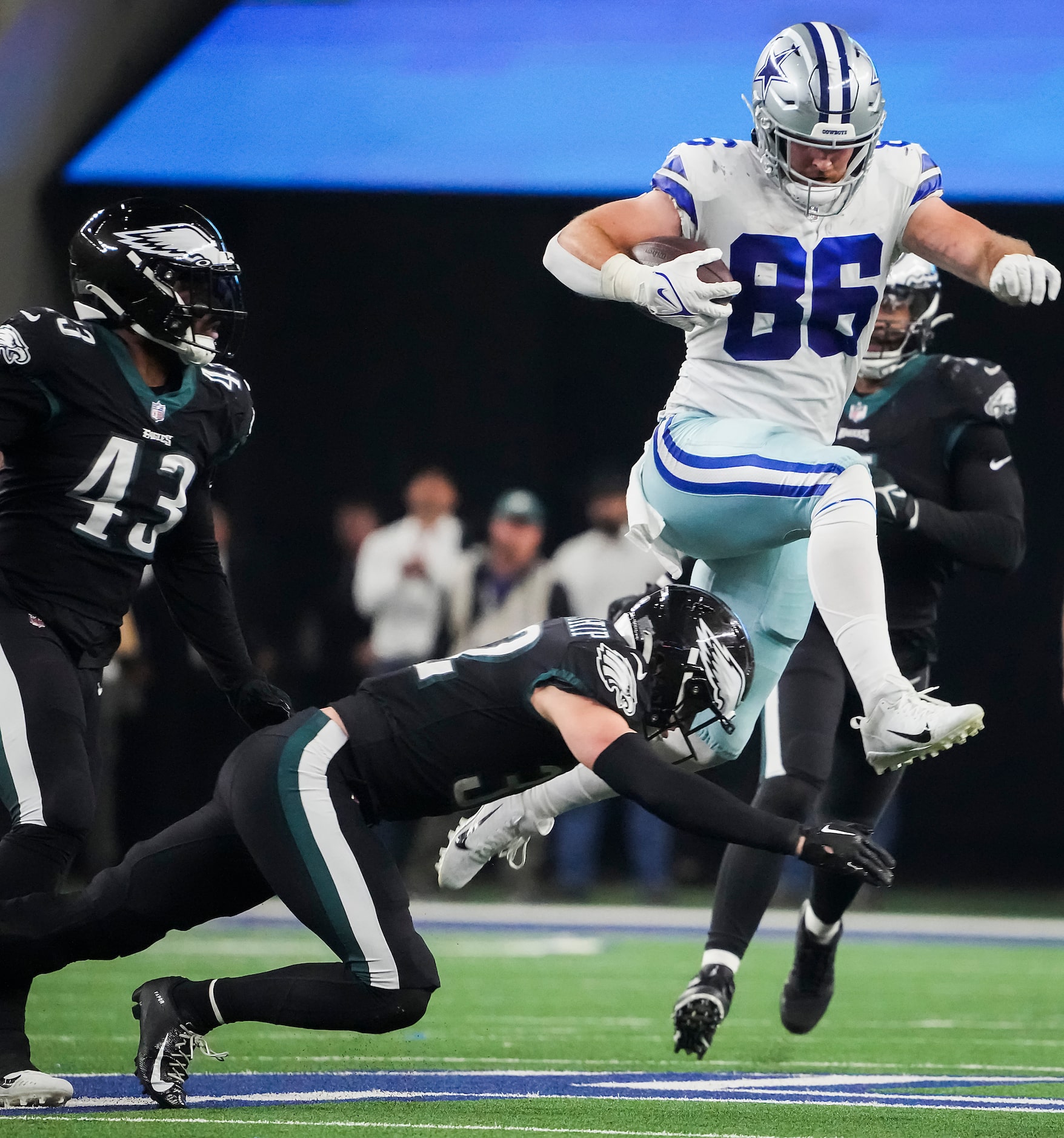 Dallas Cowboys tight end Dalton Schultz (86) leaps over Philadelphia Eagles safety Reed...