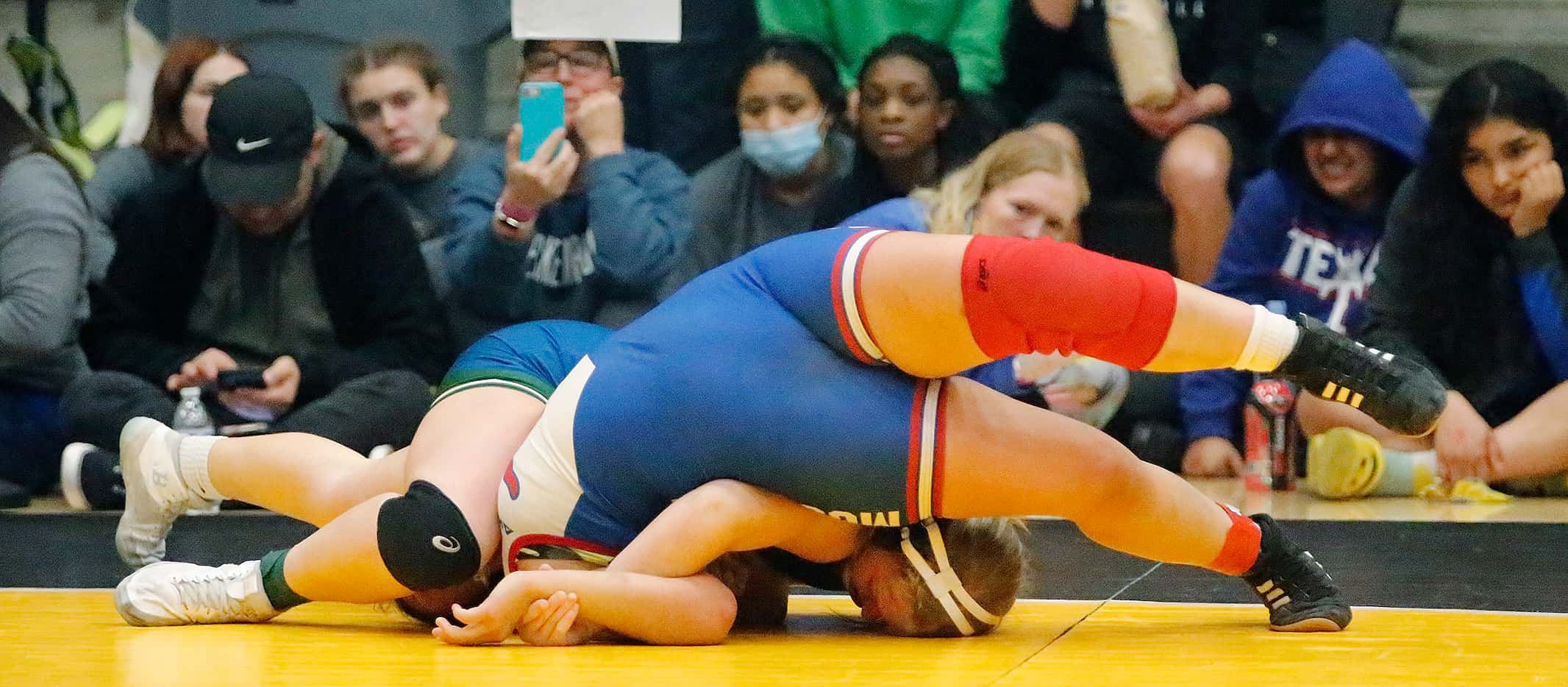Hadley Snyder (left) of Reedy High School, attempts to pin Marisol Zapata of Grapevine High...