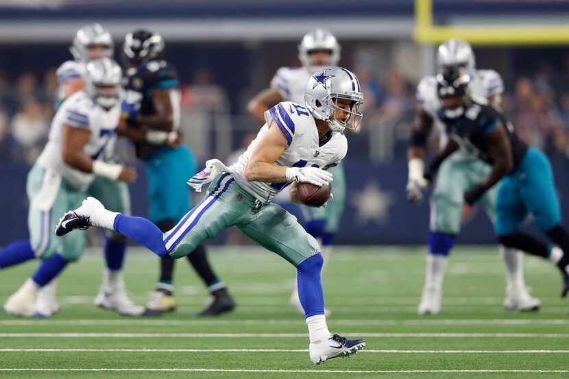 Dallas Cowboys wide receiver Cole Beasley (11) runs up the field after the catch in a game...