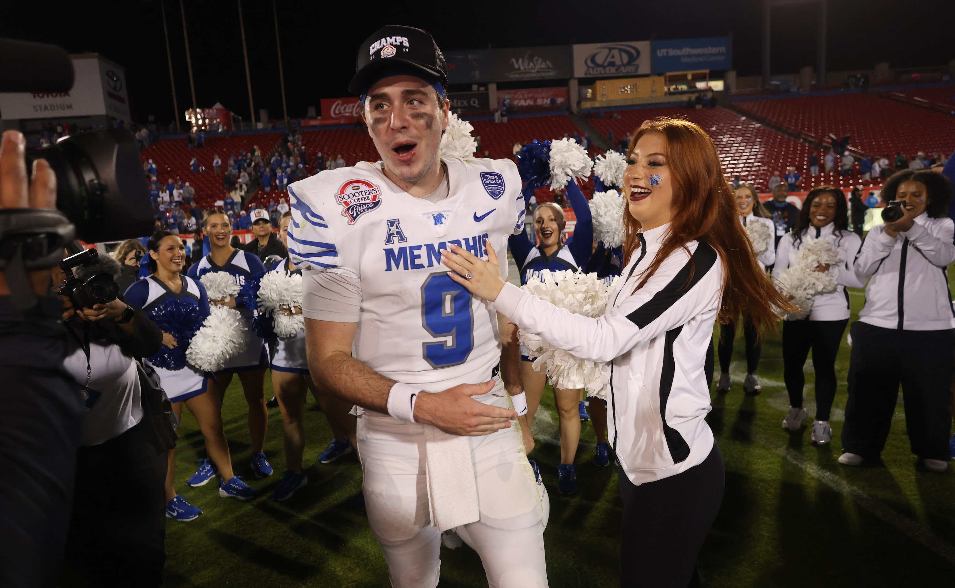 Memphis quarterback Seth Henigan (9) is congratulated by his finance' at midfield following...