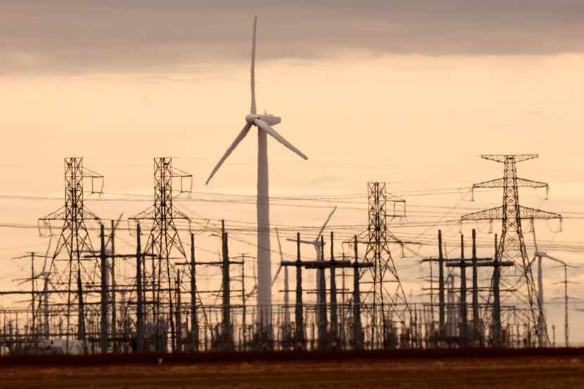 A wind turbine and power generation facility pictured along US 84 near Slaton, Texas,...