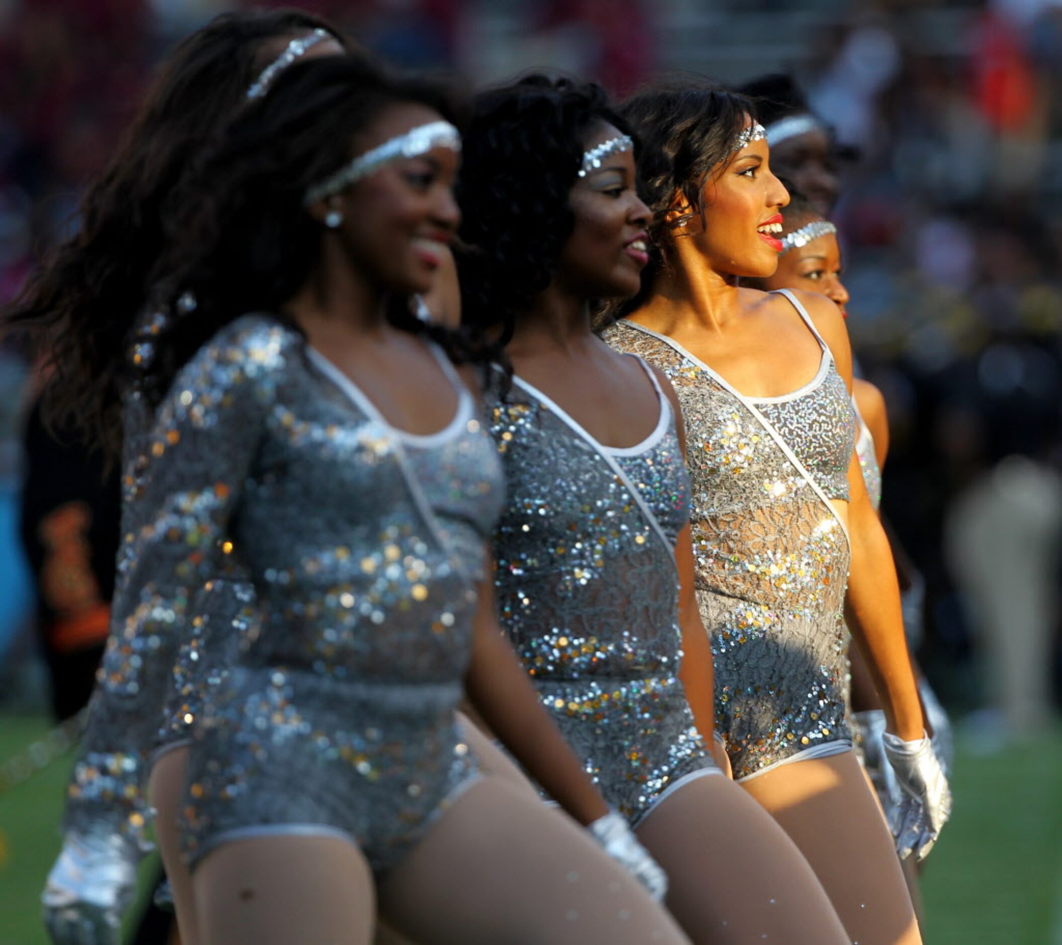 Grambling State dancers perform with the marching band at halftime during a college football...