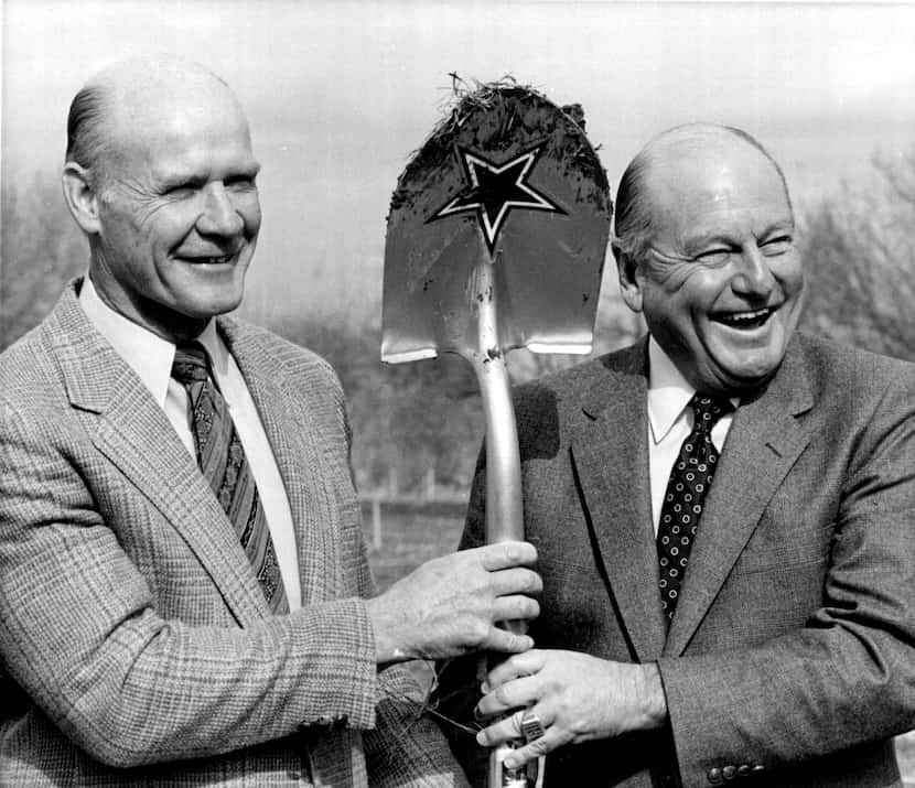 Dallas Cowboys general manager Tex Schramm, right, shares a shovel with coach Tom Landry at...