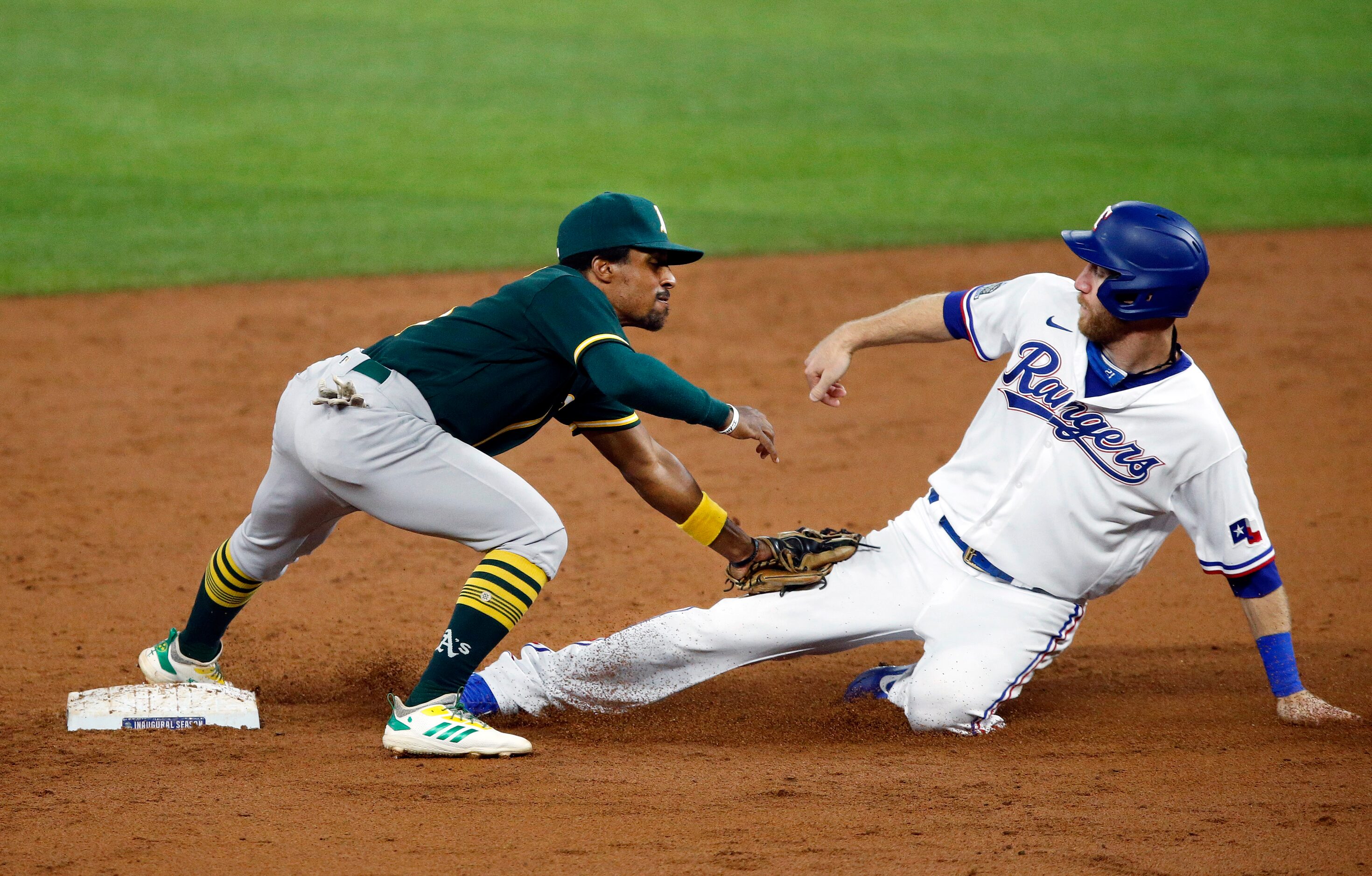 Texas Rangers Todd Frazier is tagged out by Oakland Athletics second baseman Tony Kemp (5)...