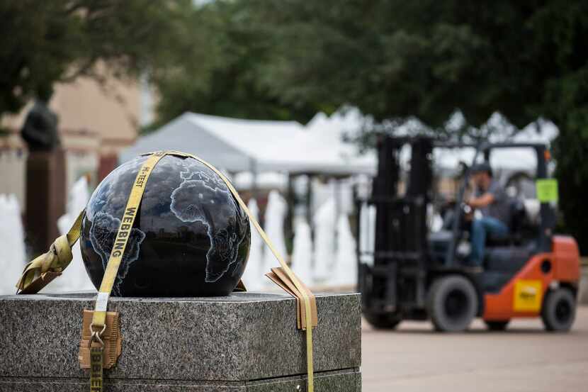 A floating sphere fountains showing the globe is staged for set up for Earth Day Texas 2017...