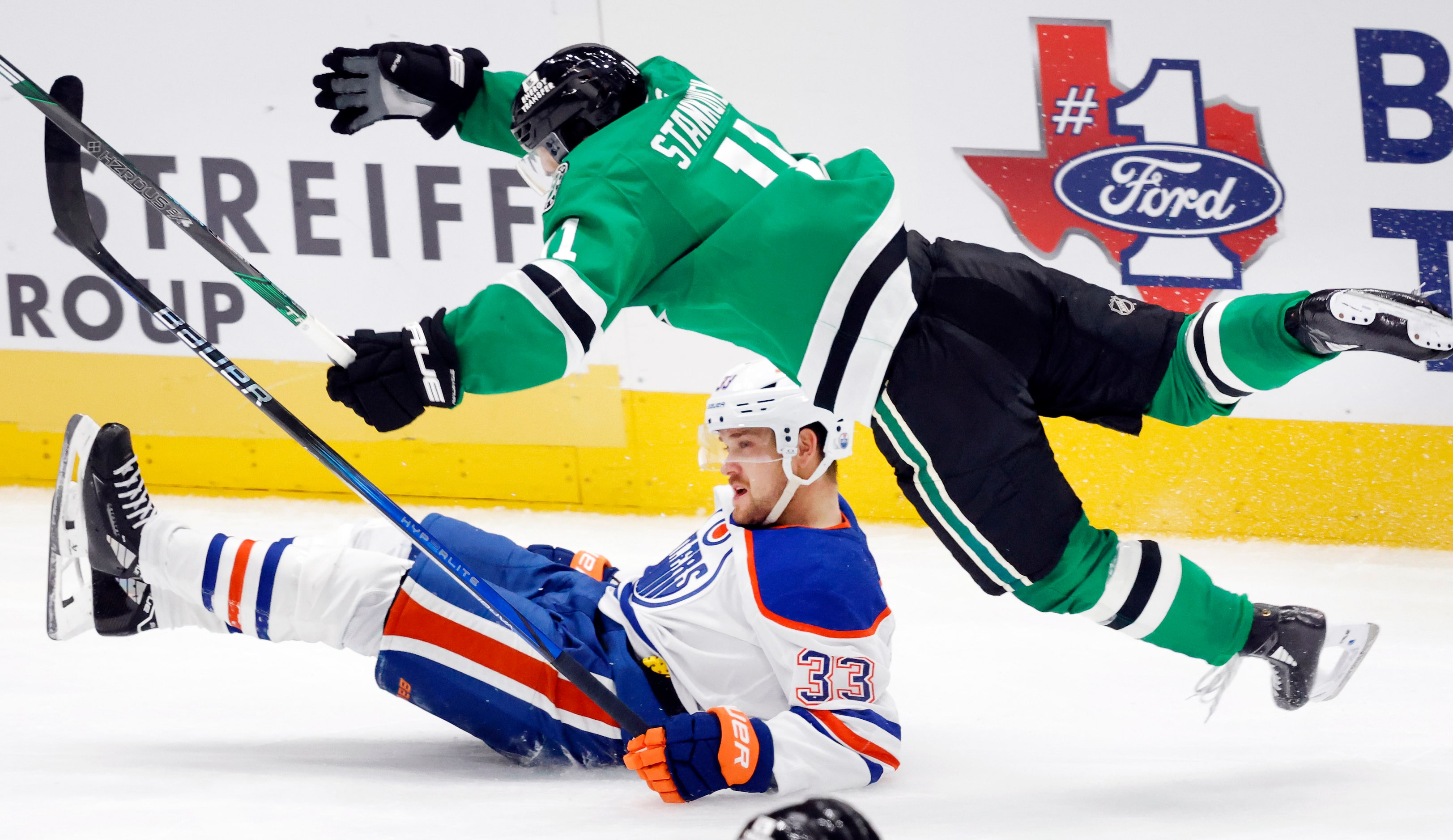 Dallas Stars center Logan Stankoven (11) is and Edmonton Oilers left wing Viktor Arvidsson...