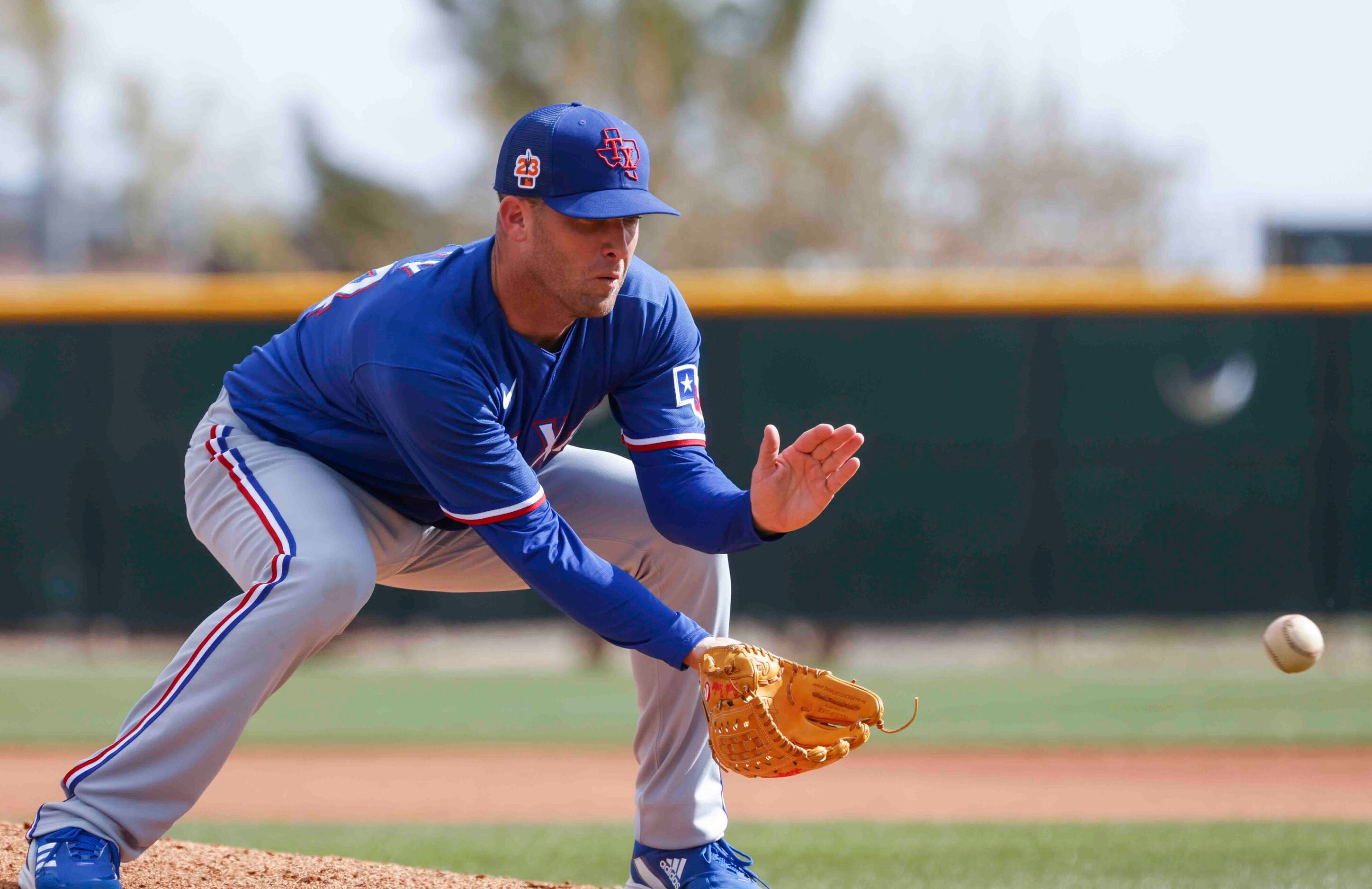 Texas Rangers pitcher Danny Duffy fields a ball during a spring training workout at the...