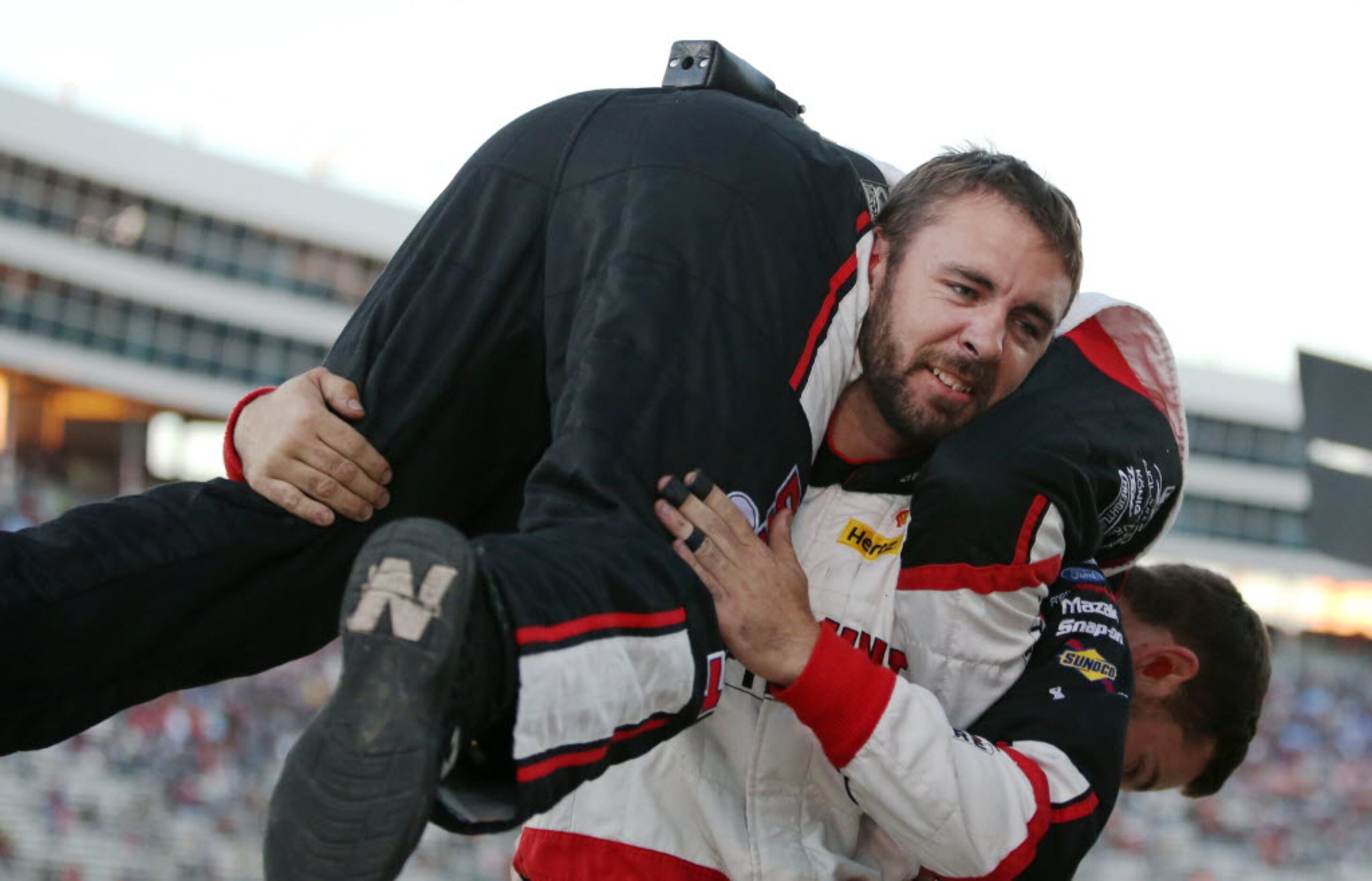 Members of the Brad Keselowski (22) pit crew celebrates after the team won the NASCAR...