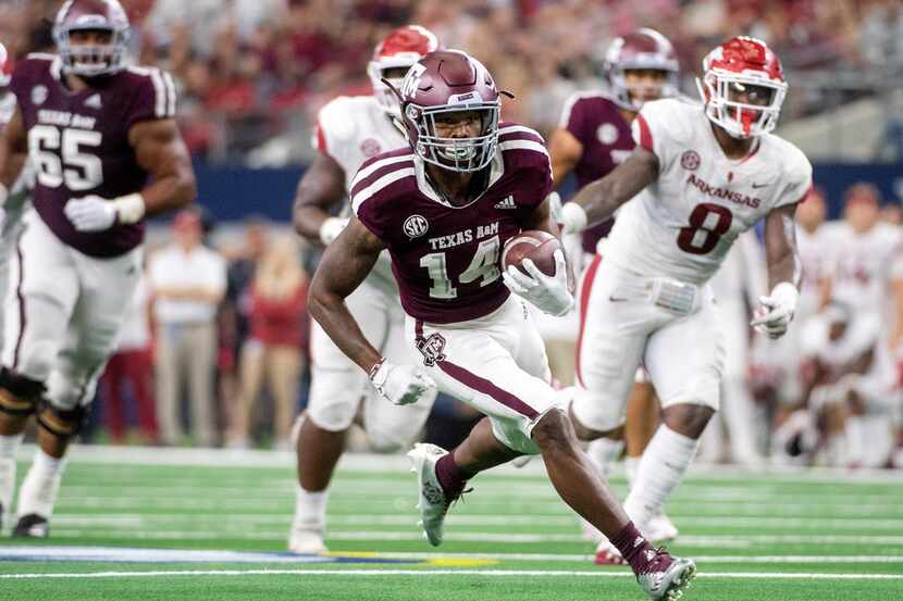 Texas A&M wide receiver Camron Buckley (14) turns upfield with a reception against Arkansas...