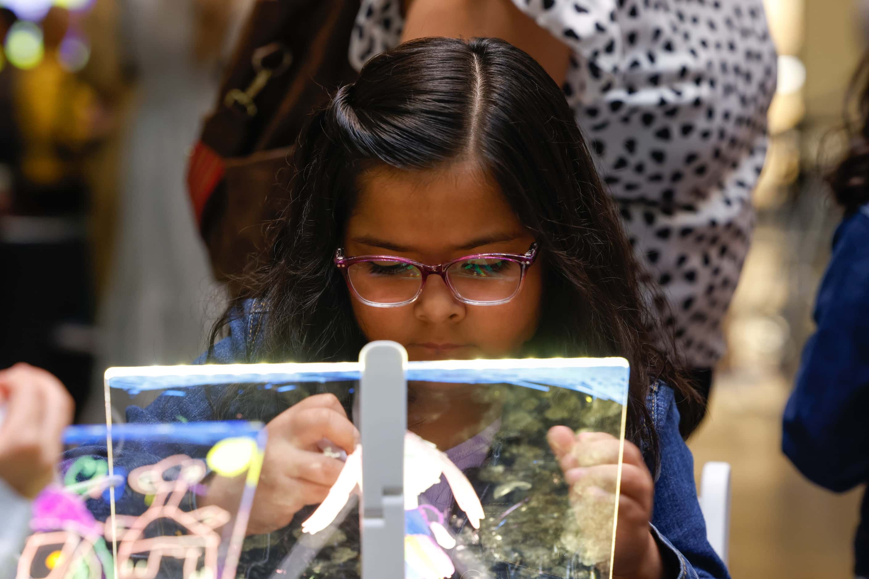 Evie Rojas, 6, participates in an activity at the NorthPark mall in Dallas on Thursday,...