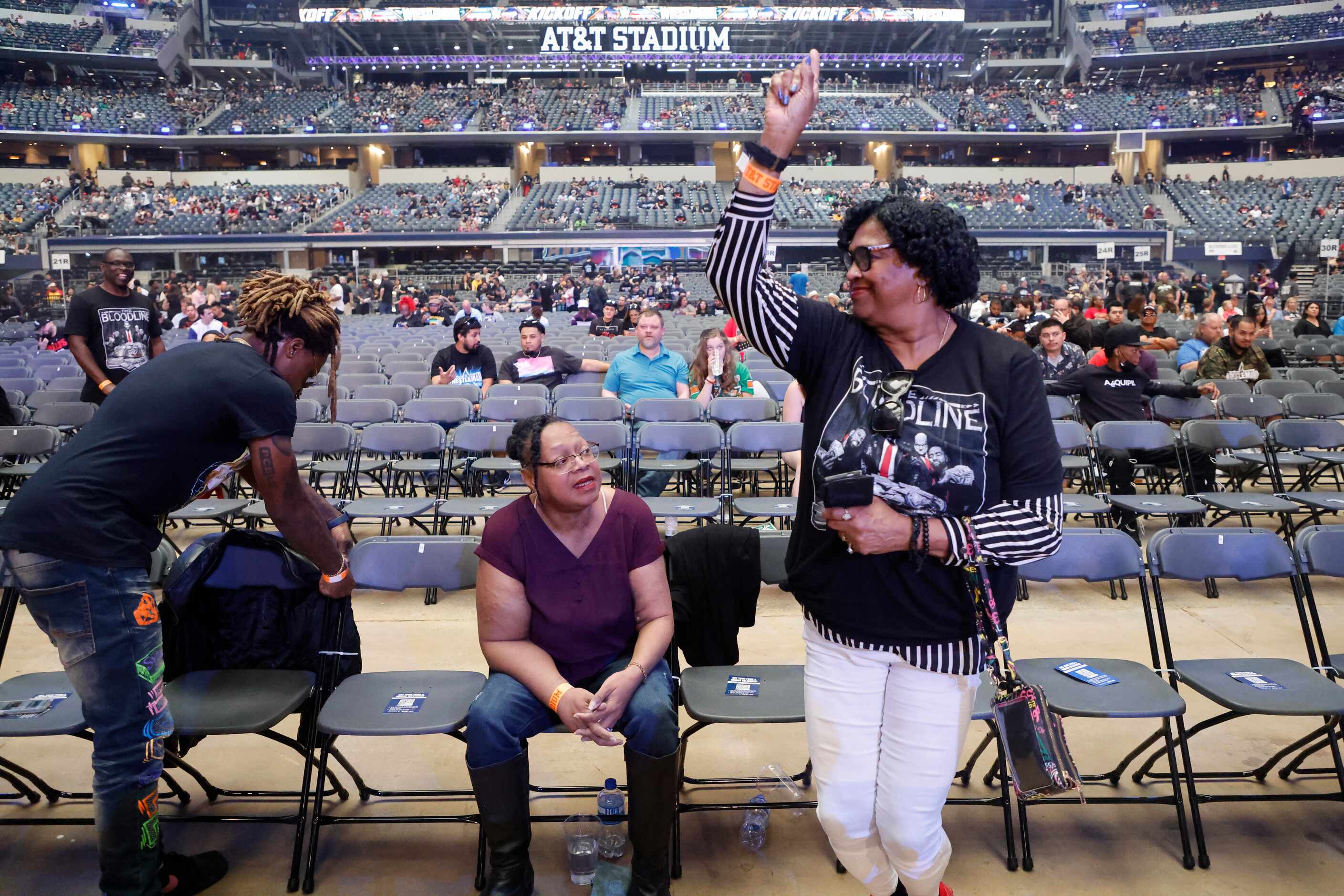 Detra Dudley, center, watches as her mother, Alberta Dudley, both from Austin, TX, dances to...