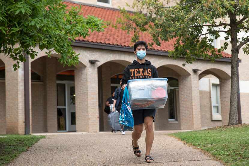 Don Le, 19, a freshman at the University of Texas, moves out of Jester dormitory for a...
