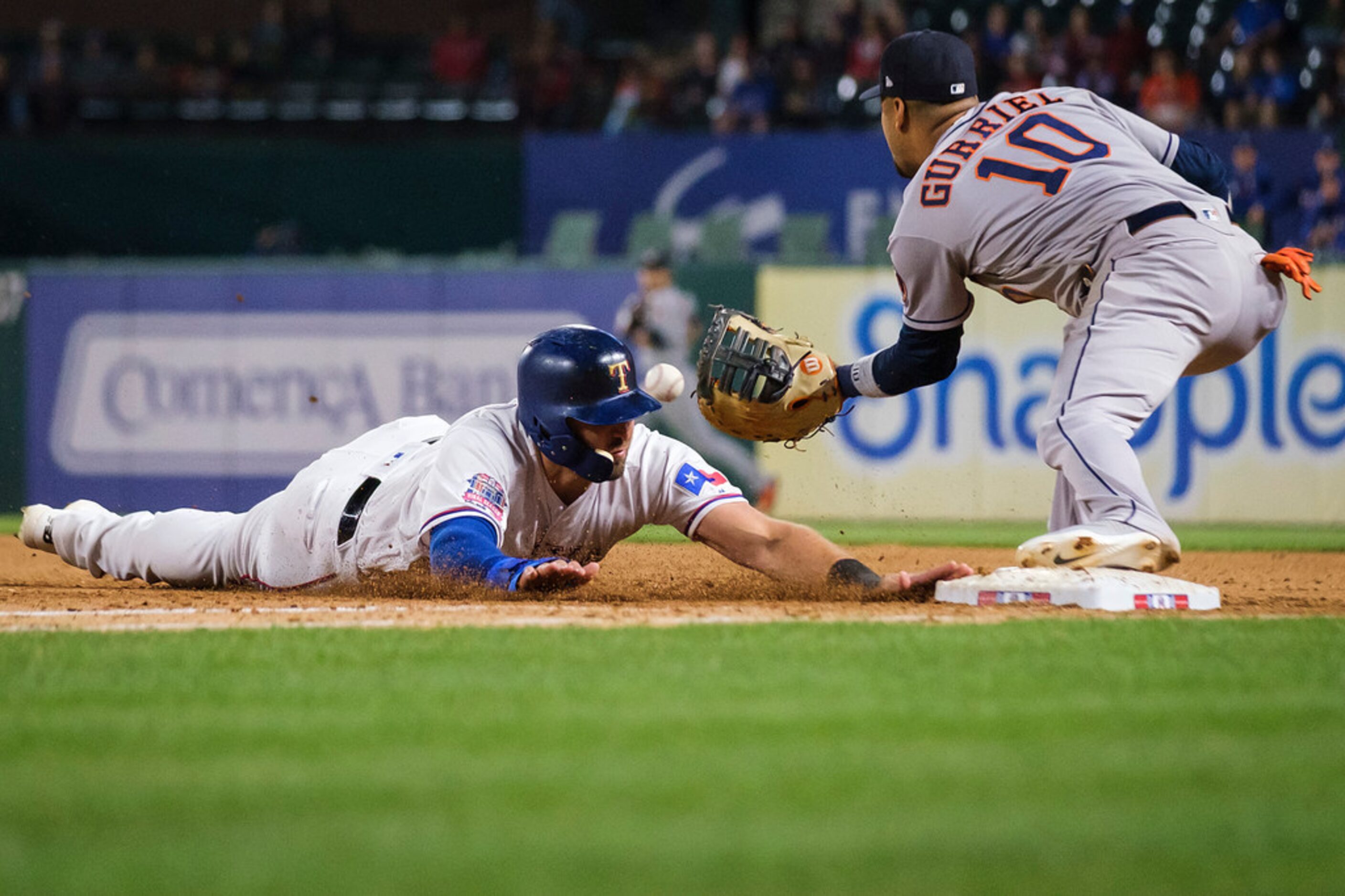 Texas Rangers designated hitter Joey Gallo beats the throw to Houston Astros first baseman...