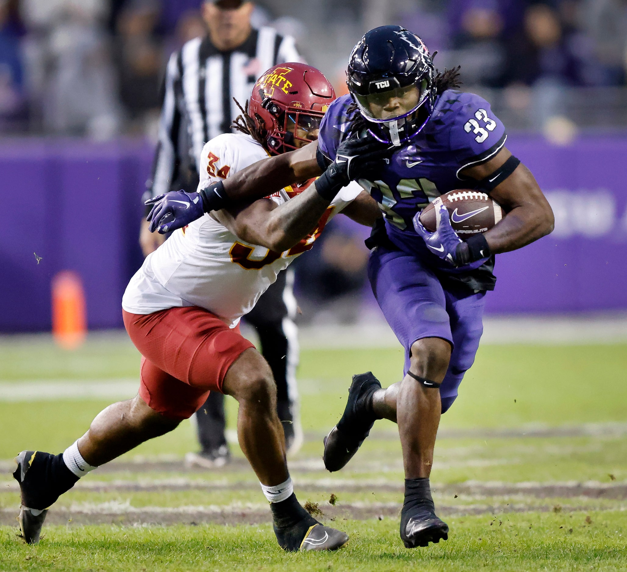 TCU Horned Frogs running back Kendre Miller (33) pushes aside Iowa State Cyclones linebacker...