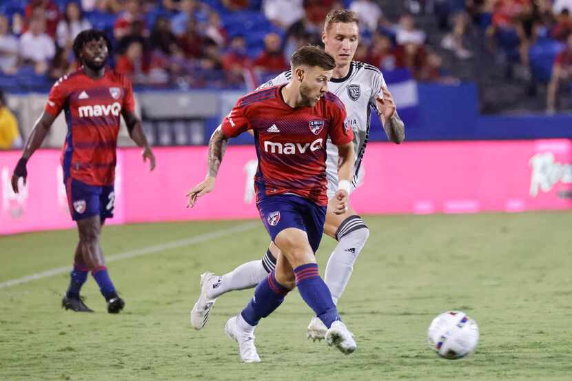 FC Dallas forward Paul Arriola, front, crosses the ball as San Jose Earthquakes forward...