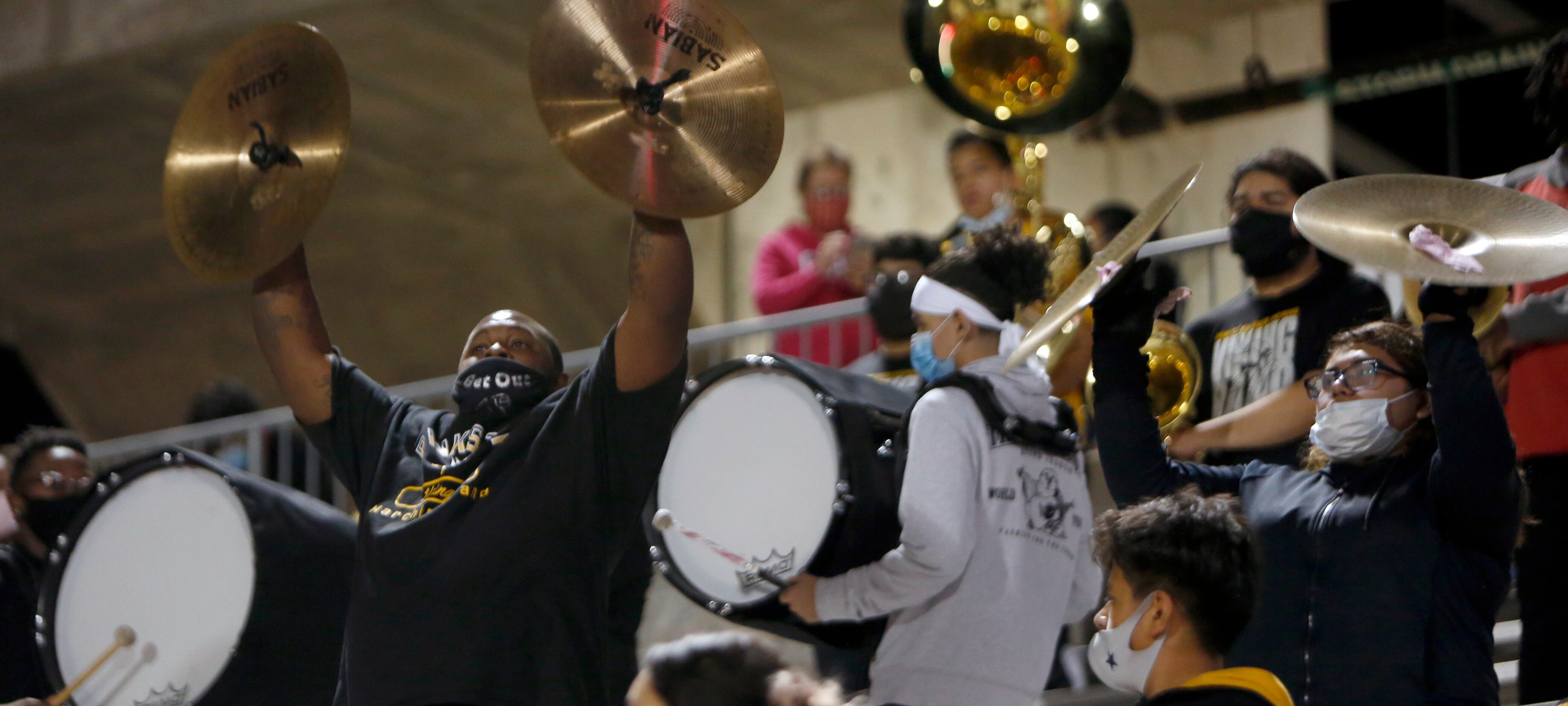 Members of the Dallas Pinkston percussion section set the beat for other band members to...