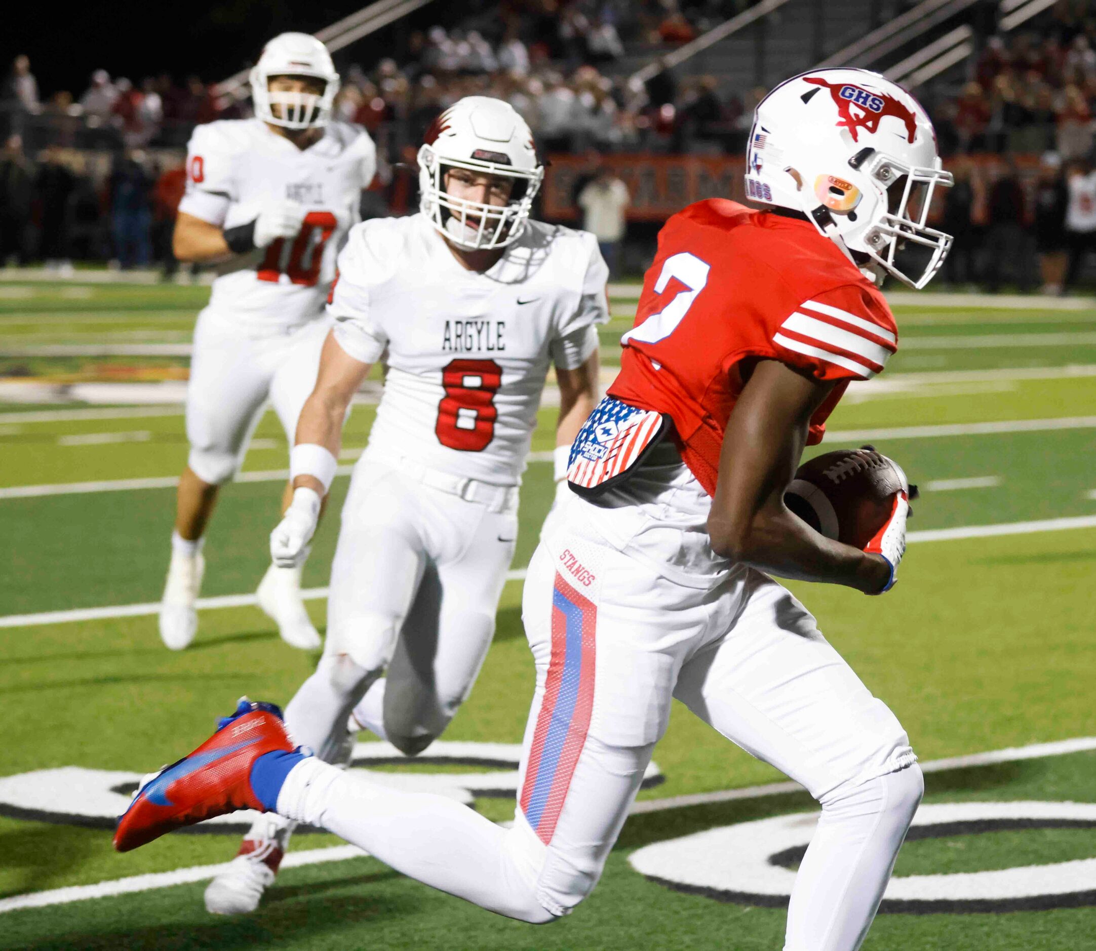 Grapevine High’s Derrius Burns (2), front, runs past Argyle High’s Devon Owen (8) during the...