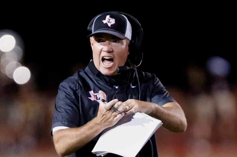 Lovejoy High School head coach Chris Ross calls a time out during the first half as Lovejoy...