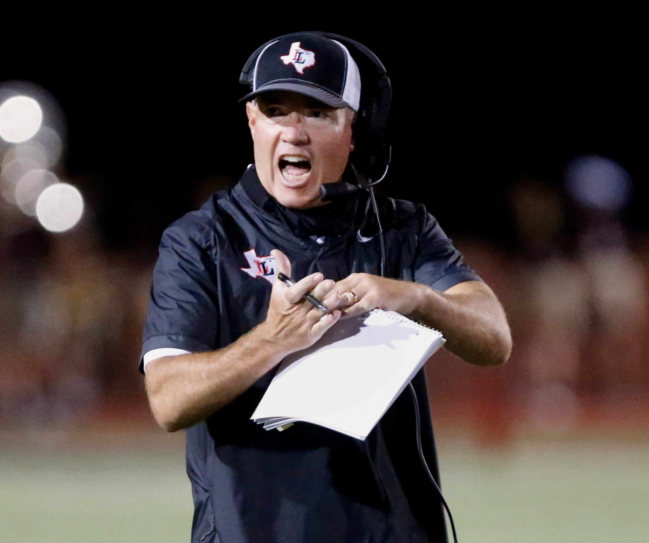 Lovejoy High School head coach Chris Ross calls a time out during the first half as Lovejoy...