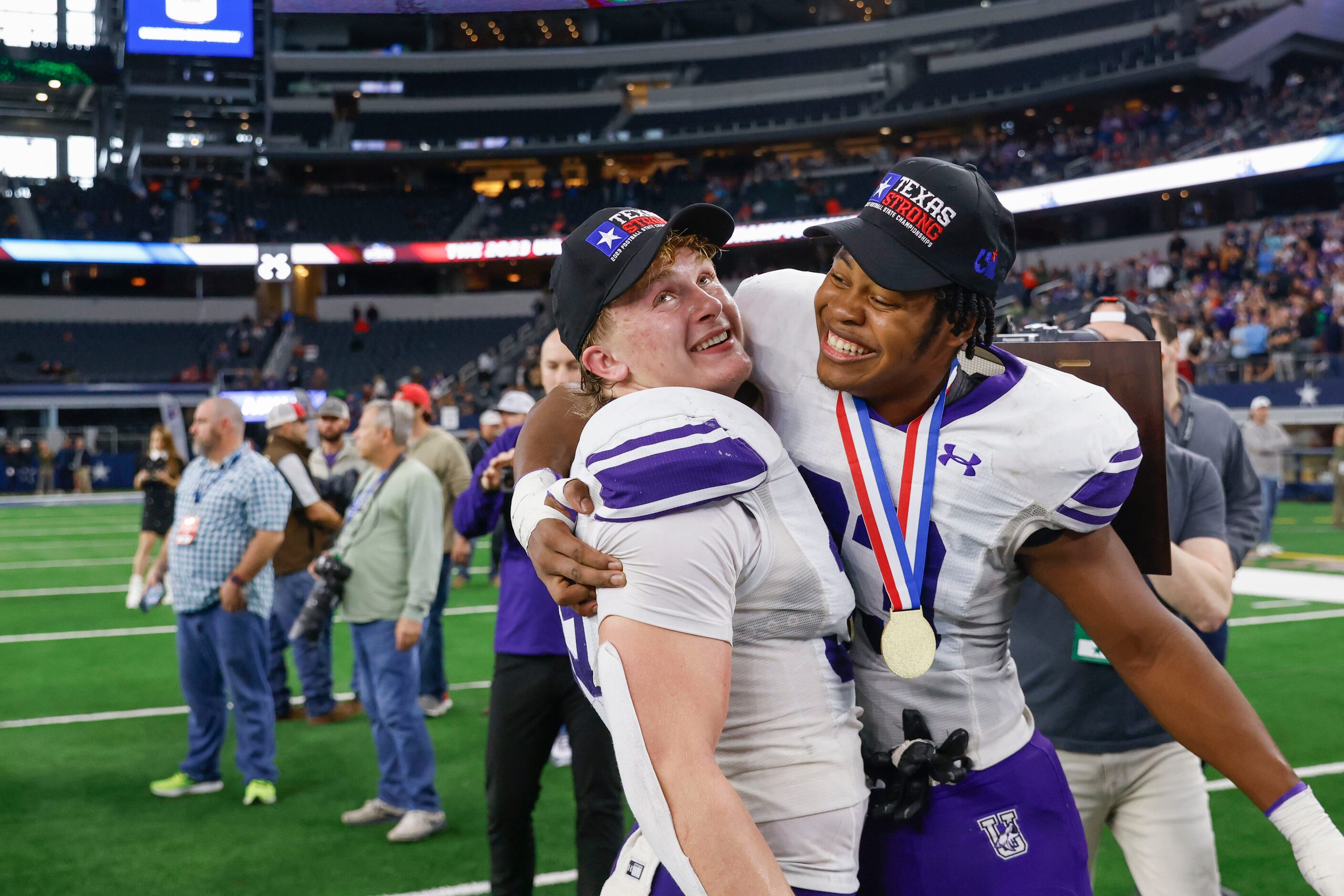 Anna High’s Middle linebacker Cj Miller (left) gets congratulated by defensive end Nathan...