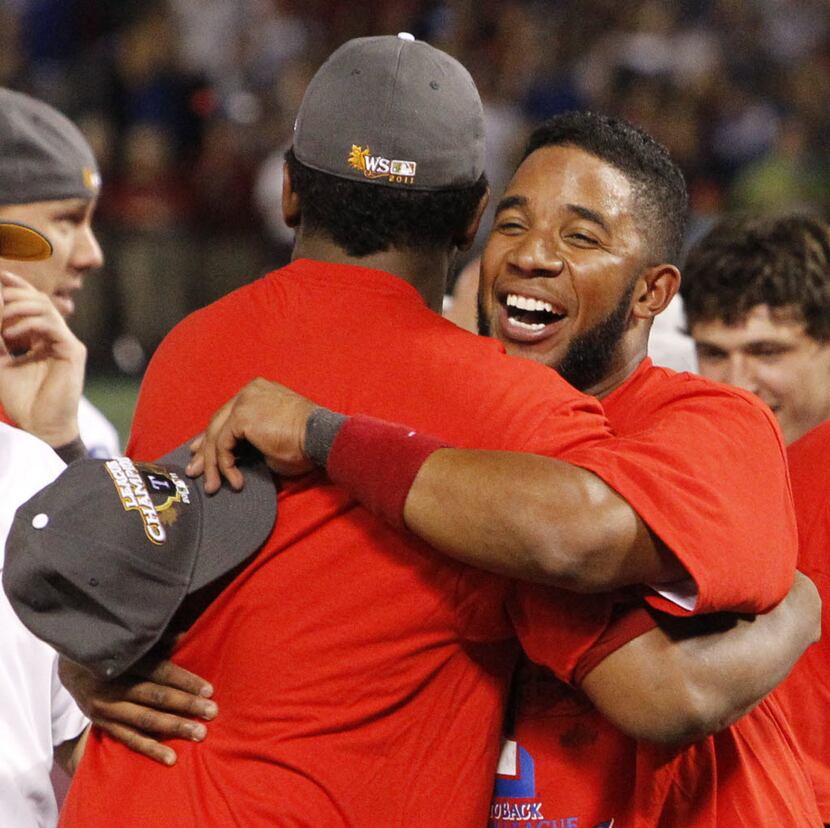 Texas SS Elvis Andrus, right, hugs RP Neftali Feliz after Game 6 of the American League...