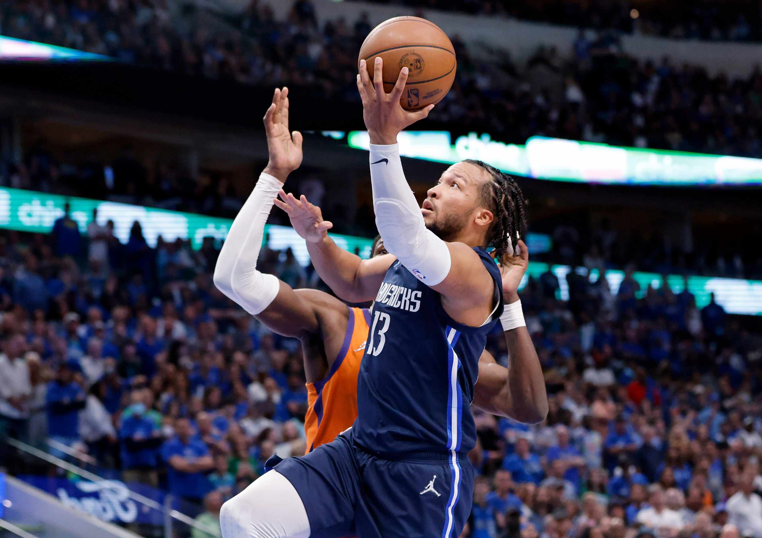 Dallas Mavericks guard Jalen Brunson (13) makes a running layup past Phoenix Suns center...