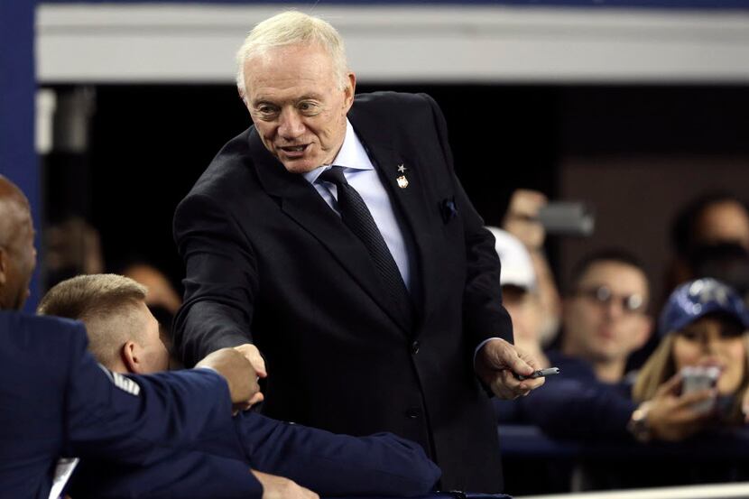 Dallas Cowboys owner Jerry Jones talks with fans before a game between the Dallas Cowboys...
