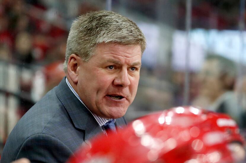 The Canes' head coach Bill Peters directs the team during the second period of an NHL game...