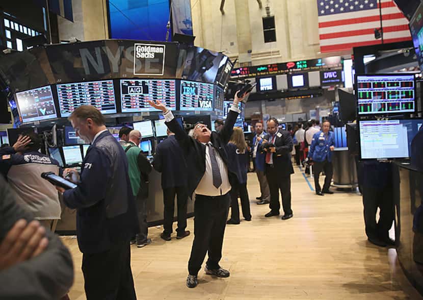  Trader Peter Tuchman throws his hands in the air at the closing bell of the New York Stock...