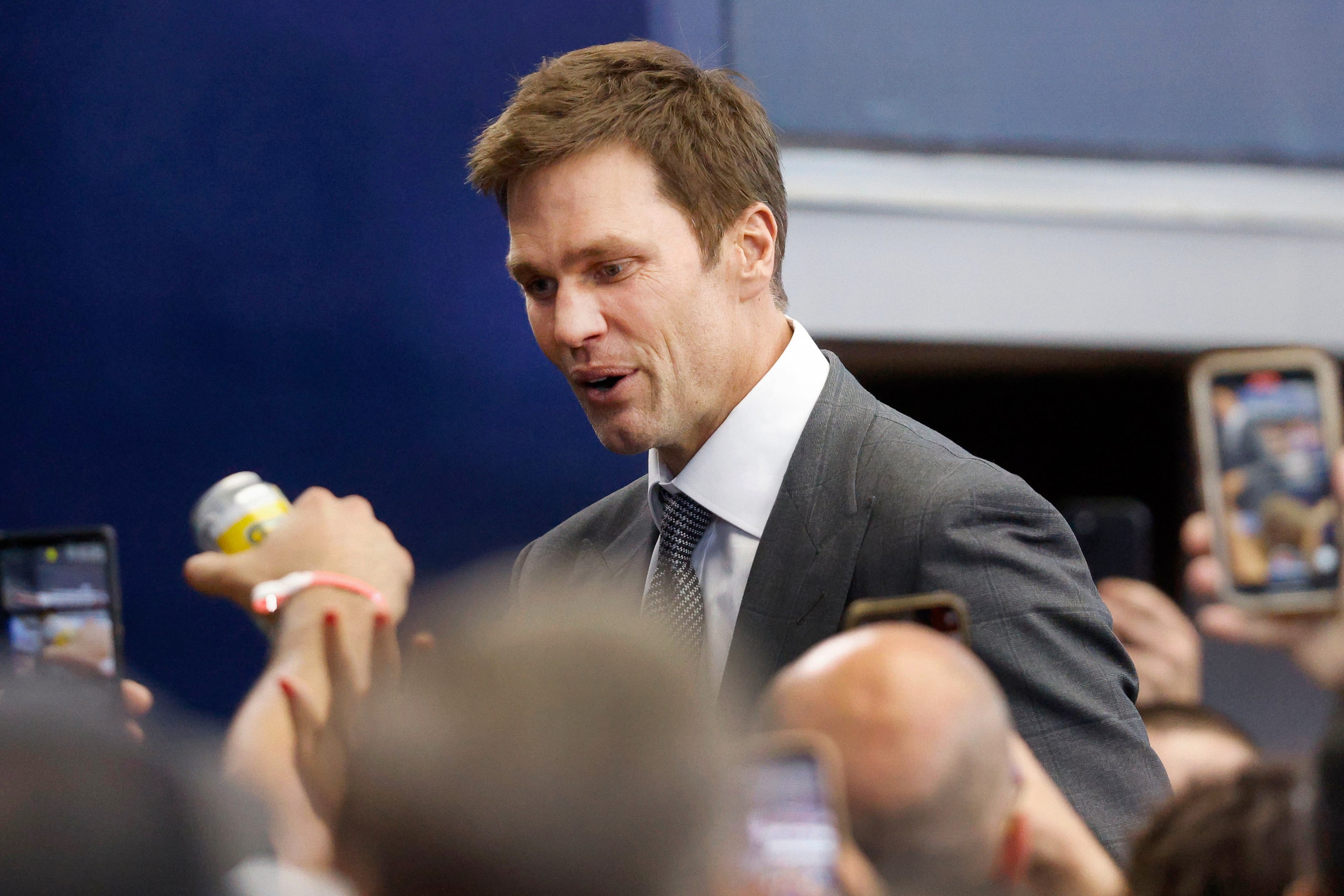 Former quarterback Tom Brady smiles to fans before an NFL football game between the Dallas...