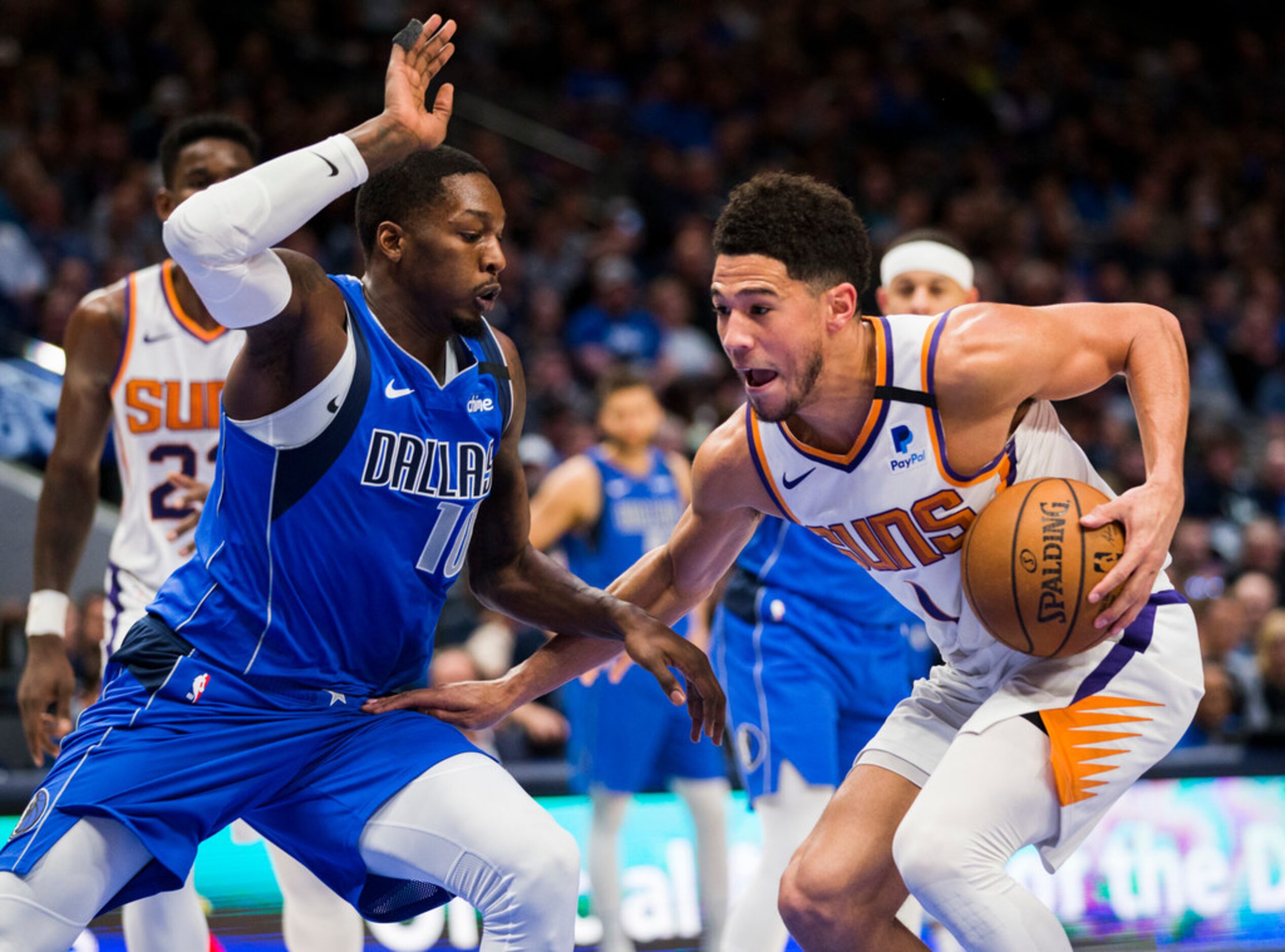 Dallas Mavericks forward Dorian Finney-Smith (10) defends against Phoenix Suns guard Devin...