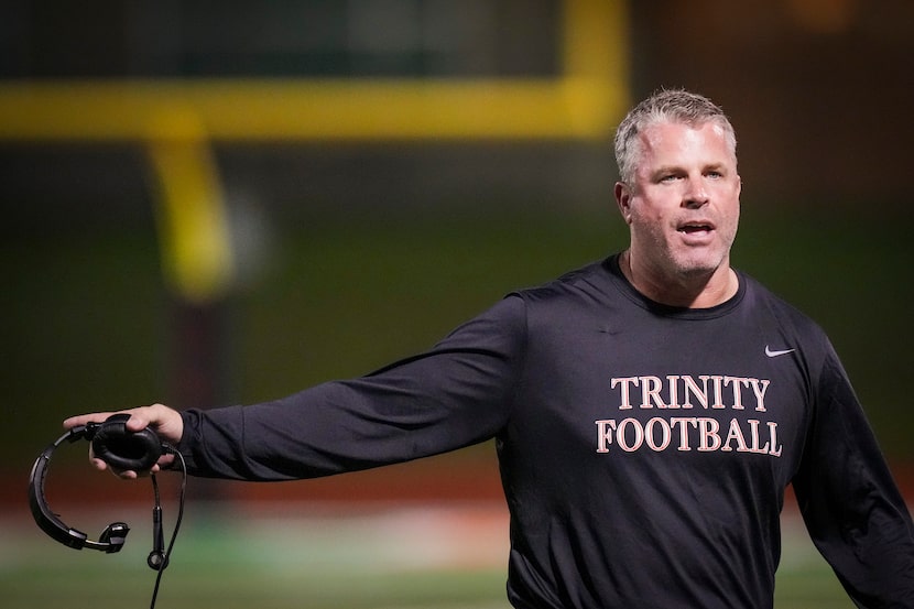 Euless Trinity head coach Aaron Lineweaver works the sideline during the first half of a...