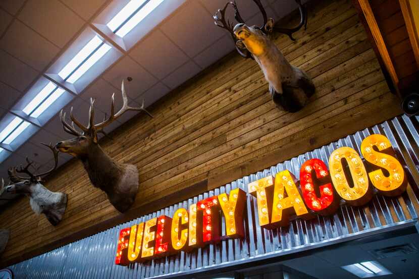 Heads of animals are displayed over the taco window at a new Fuel City location on Friday,...