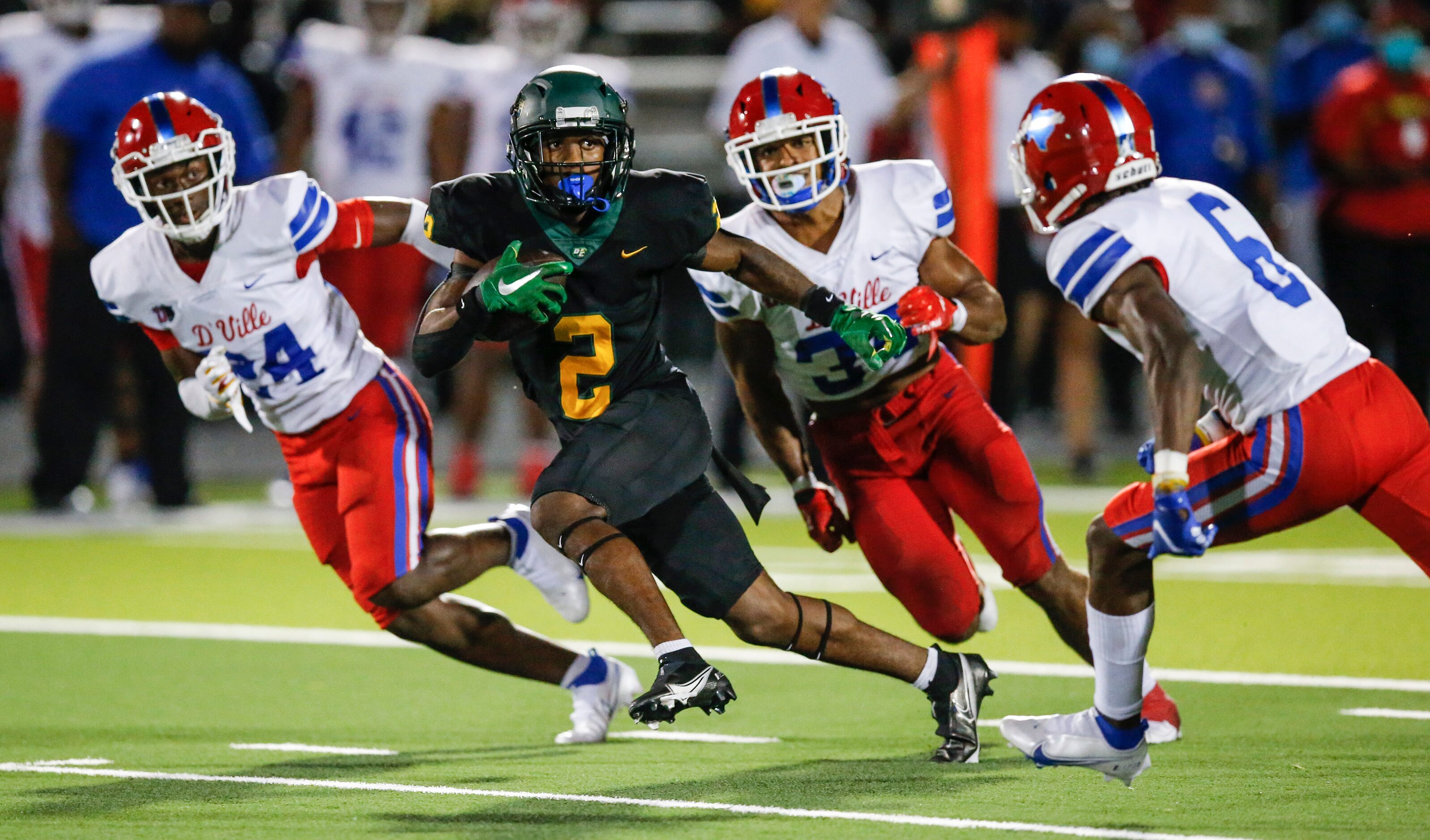 DeSoto senior wide receiver Mike Murphy (2) carries the ball against the Duncanville defense...