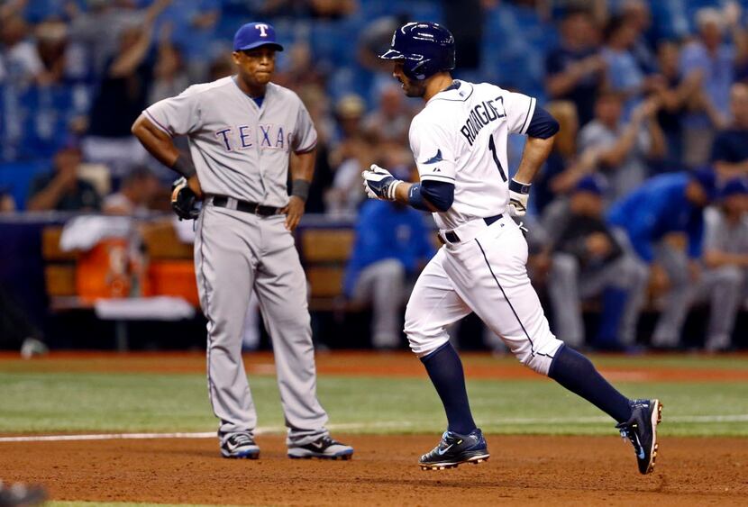Tampa Bay Rays' Sean Rodriguez rounds the bases in front of Texas Rangers third baseman...