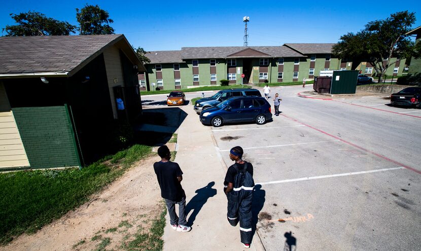 Norris Criddle, left, and Brandon Washington chat as they walk past the laundry room at the...